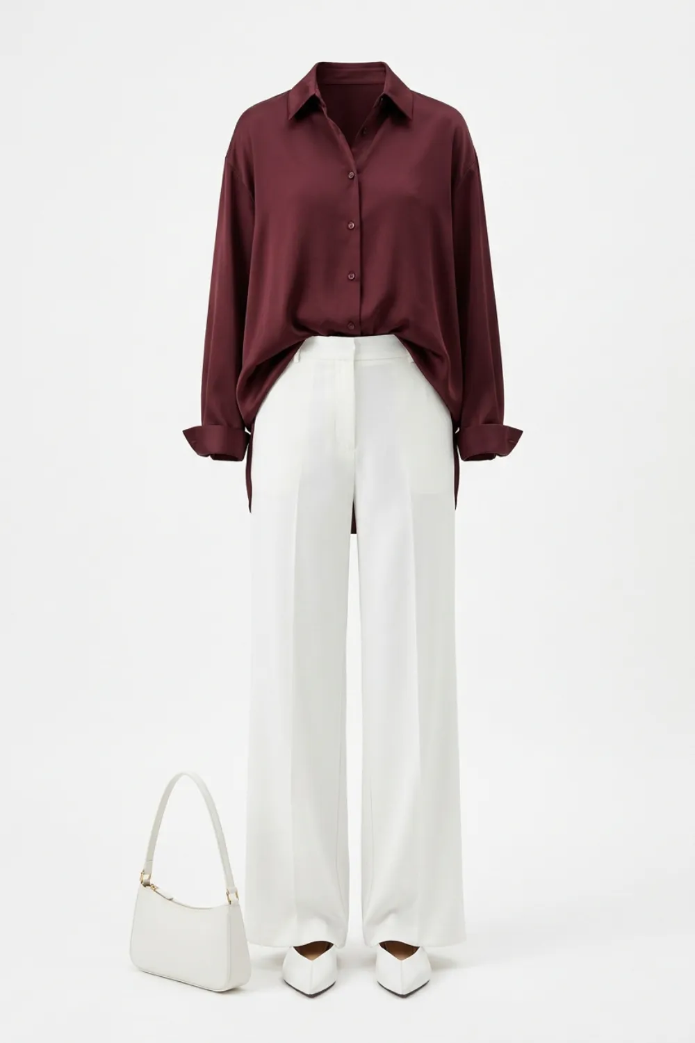Flat lay of a burgundy blouse, white wide-leg trousers, a white shoulder bag and white pointed flats