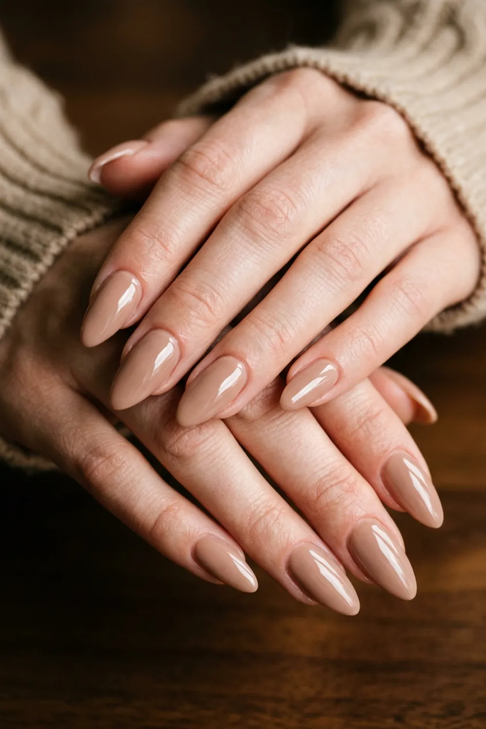 Glossy almond nails in a solid latte brown nude shade