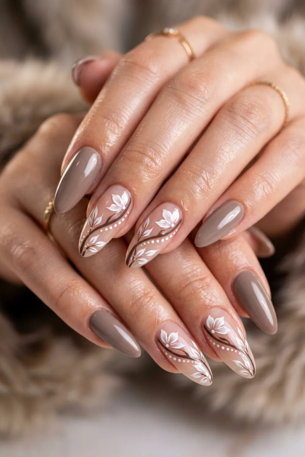 Almond nails in taupe brown with white leaf swirl art on nude accent nails