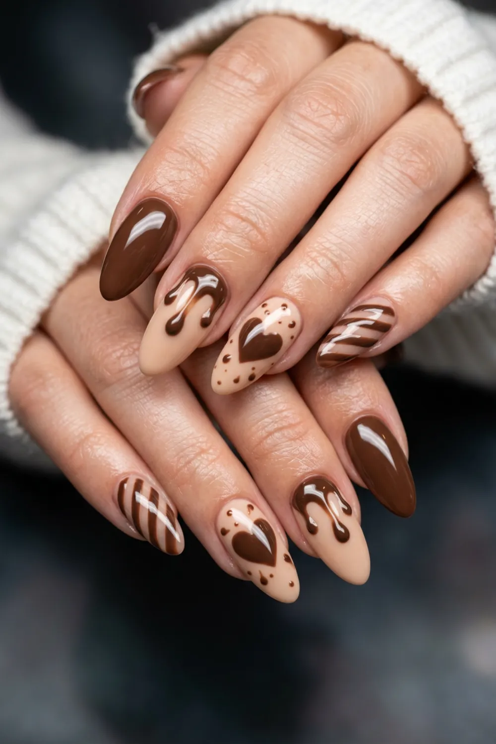 Almond nails in chocolate brown and cream with drips, hearts, stripes and dots