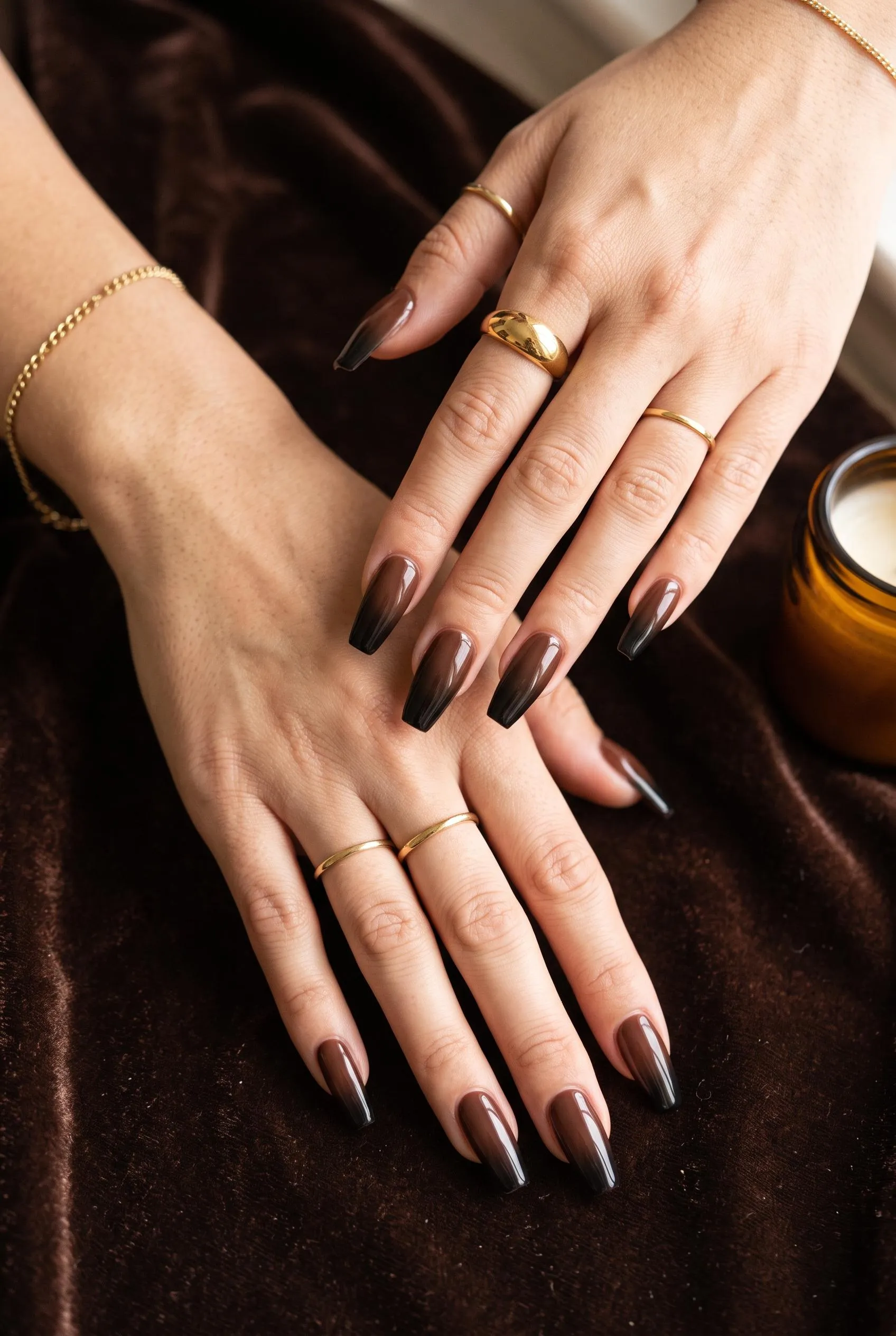 Long coffin nails with a chocolate brown to black ombre on brown velvet