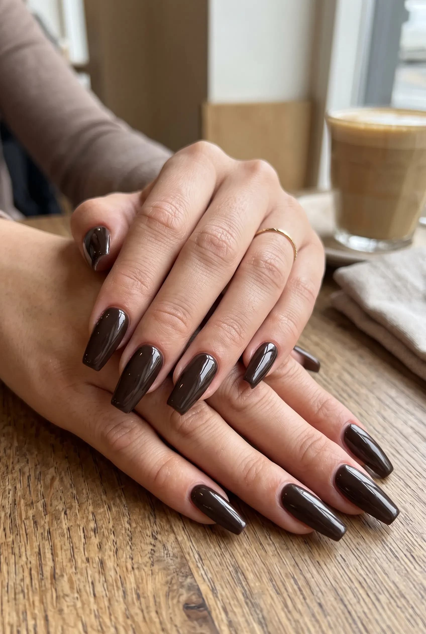 Mocha brown coffin nails with rose gold leaf art on nude accent nails