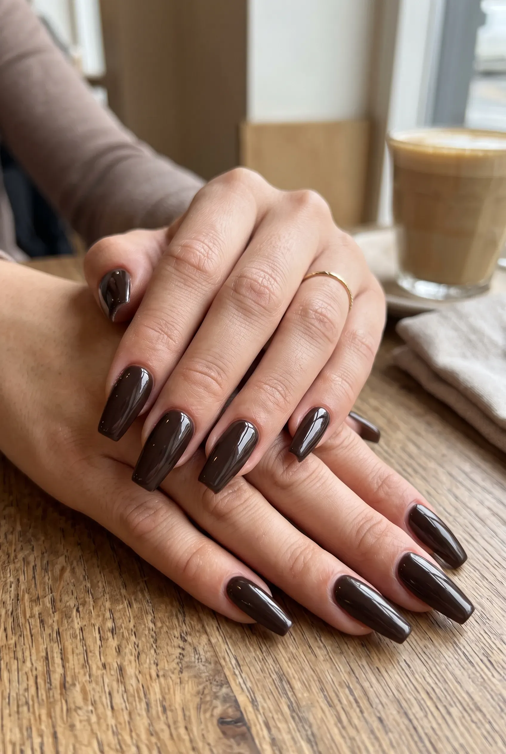 Mocha brown coffin nails with rose gold leaf art on nude accent nails
