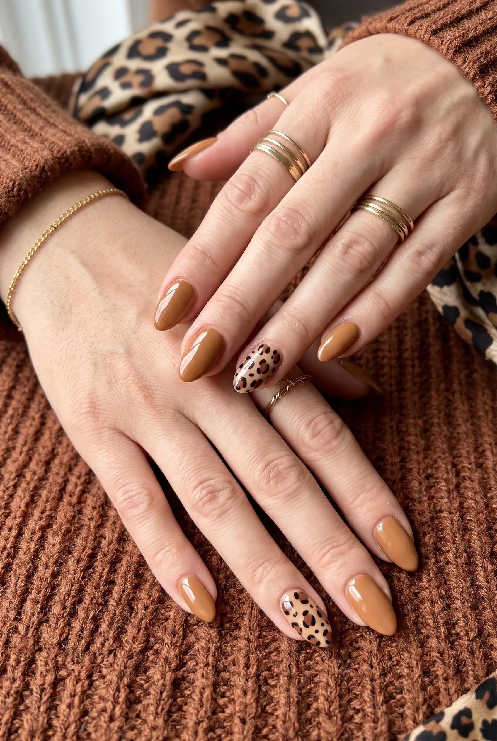 Caramel almond nails with brown leopard print on the ring fingers