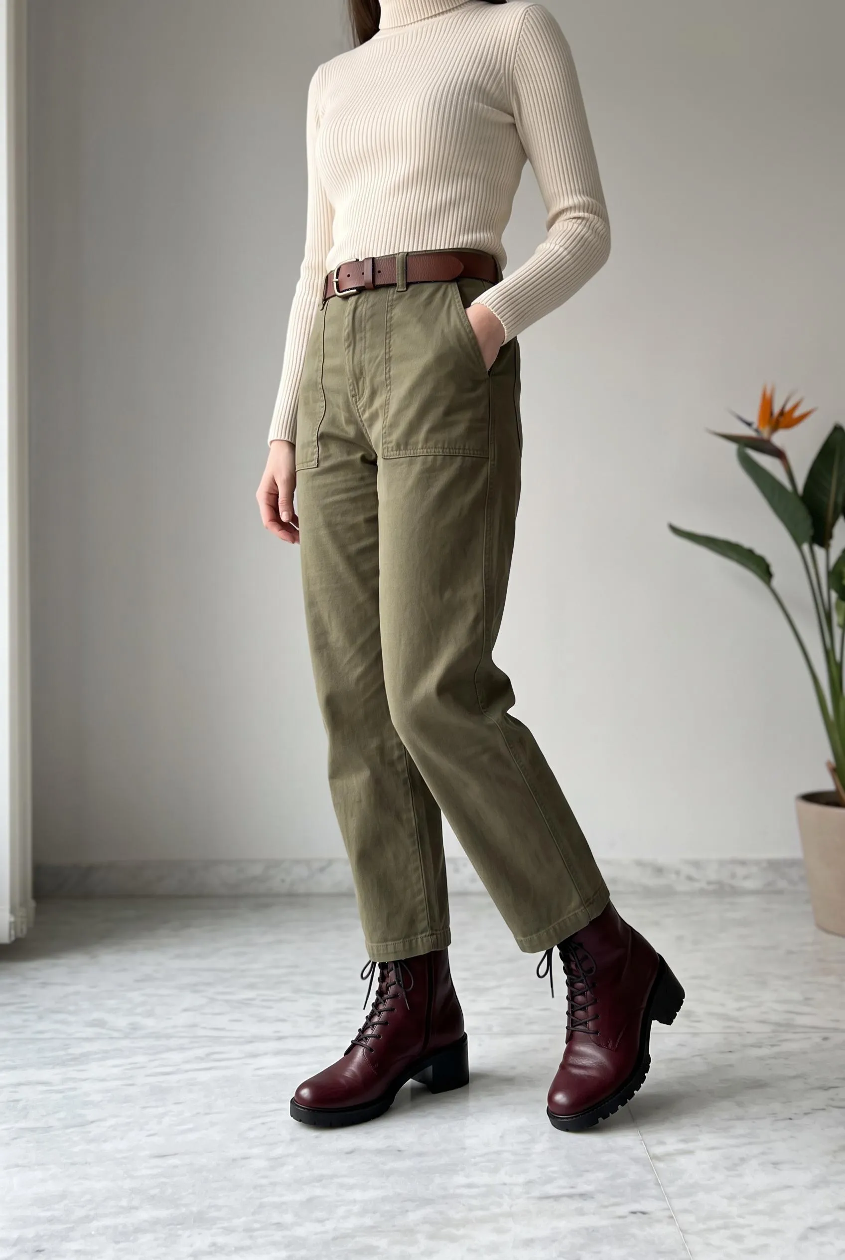 Burgundy lace-up ankle boots with olive utility trousers and a cream turtleneck