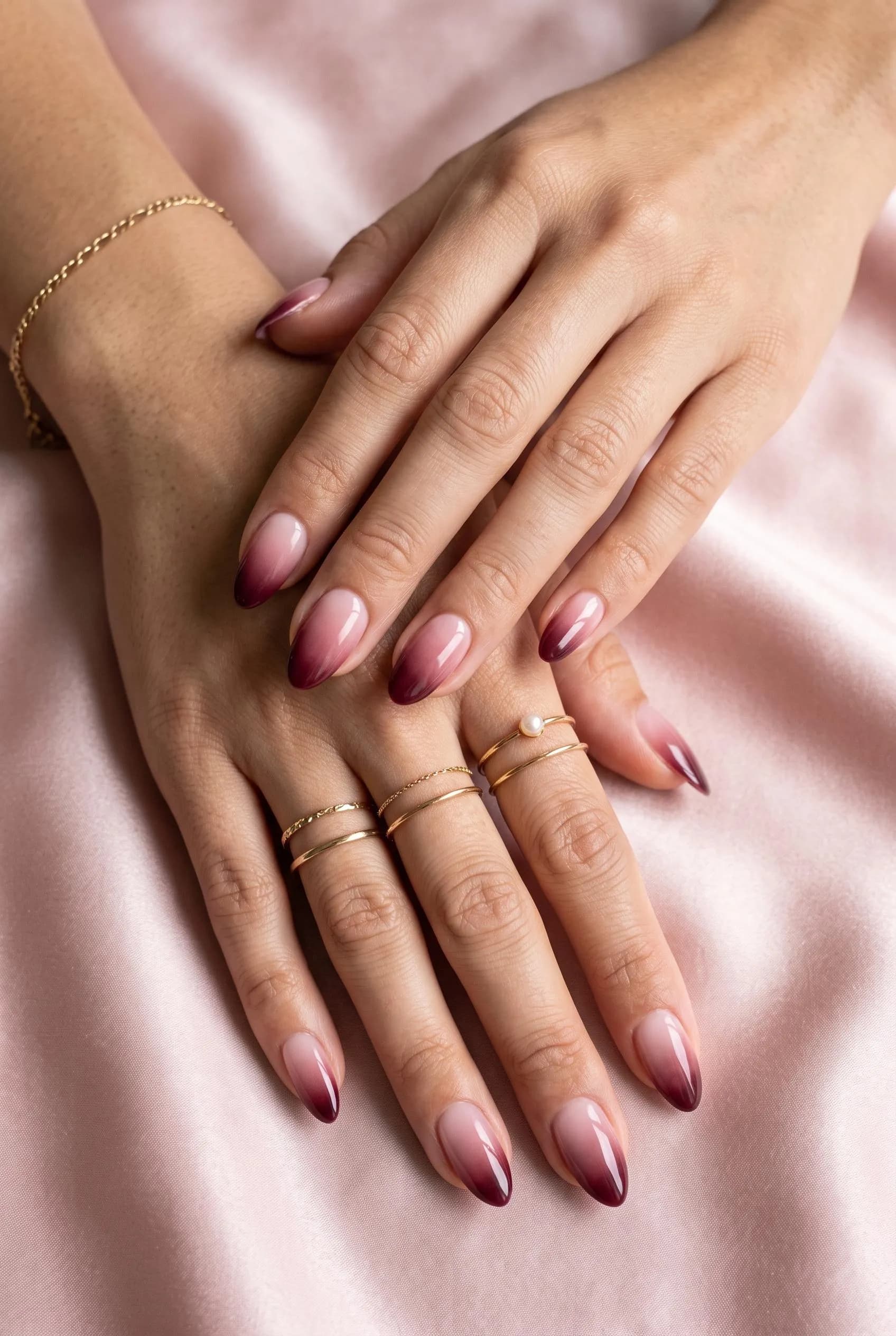 Nude to burgundy ombre almond nails on blush-pink silk