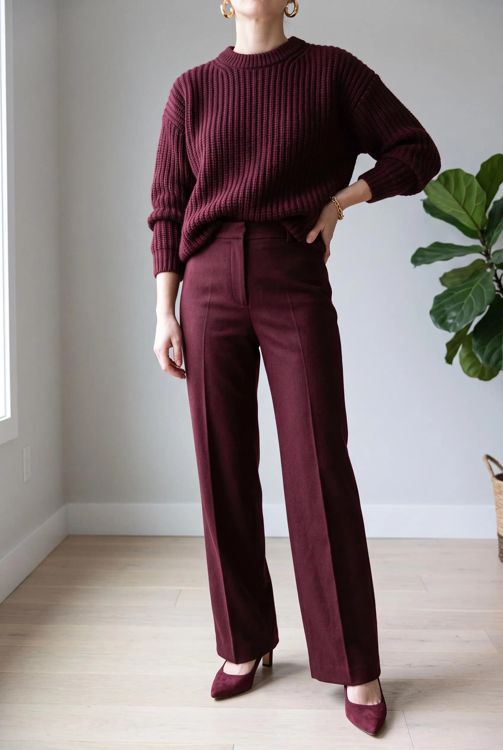 Head-to-toe burgundy ribbed knit, wide-leg wool trousers and suede pumps