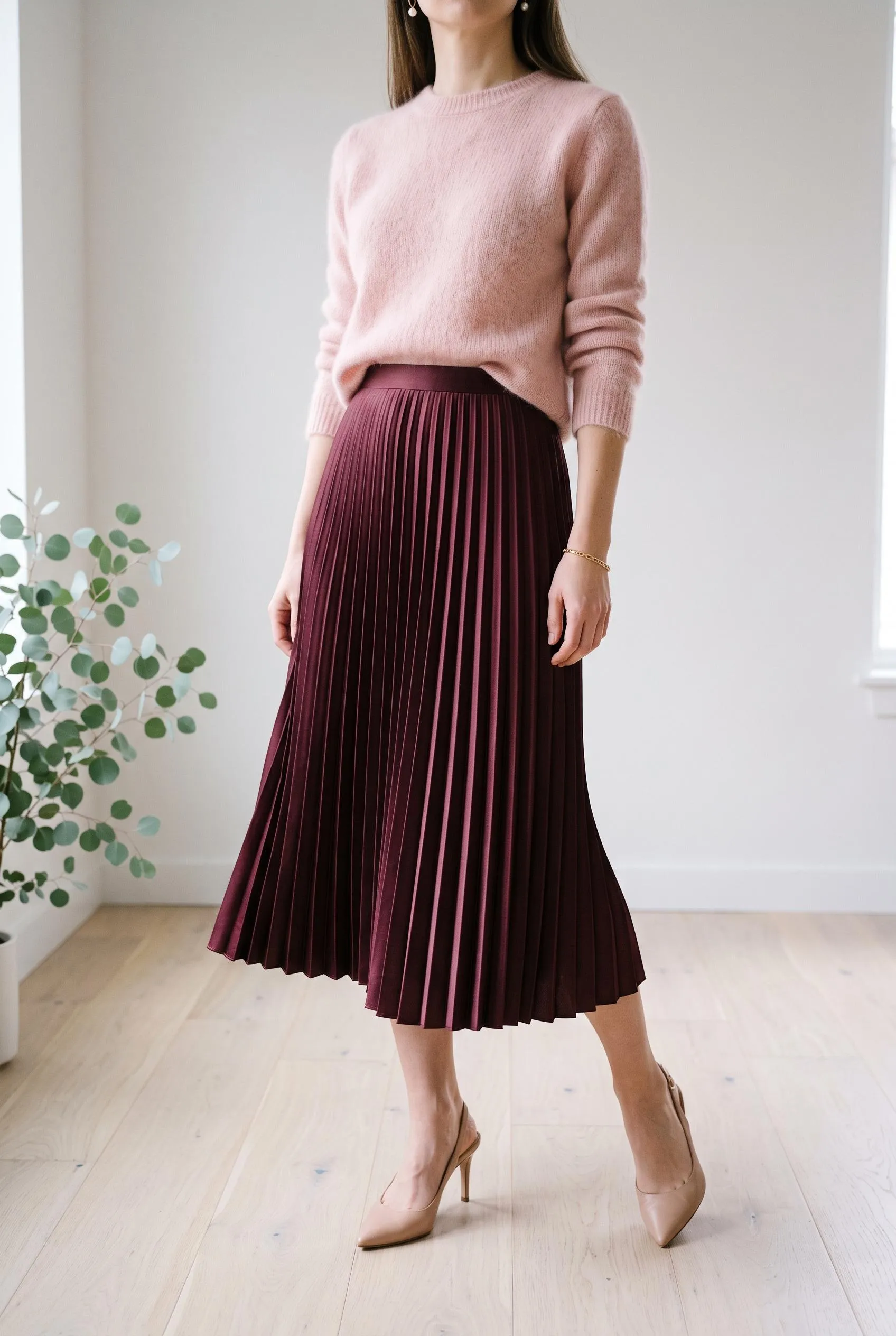 Blush pink fluffy sweater with a burgundy pleated satin midi skirt and nude heels