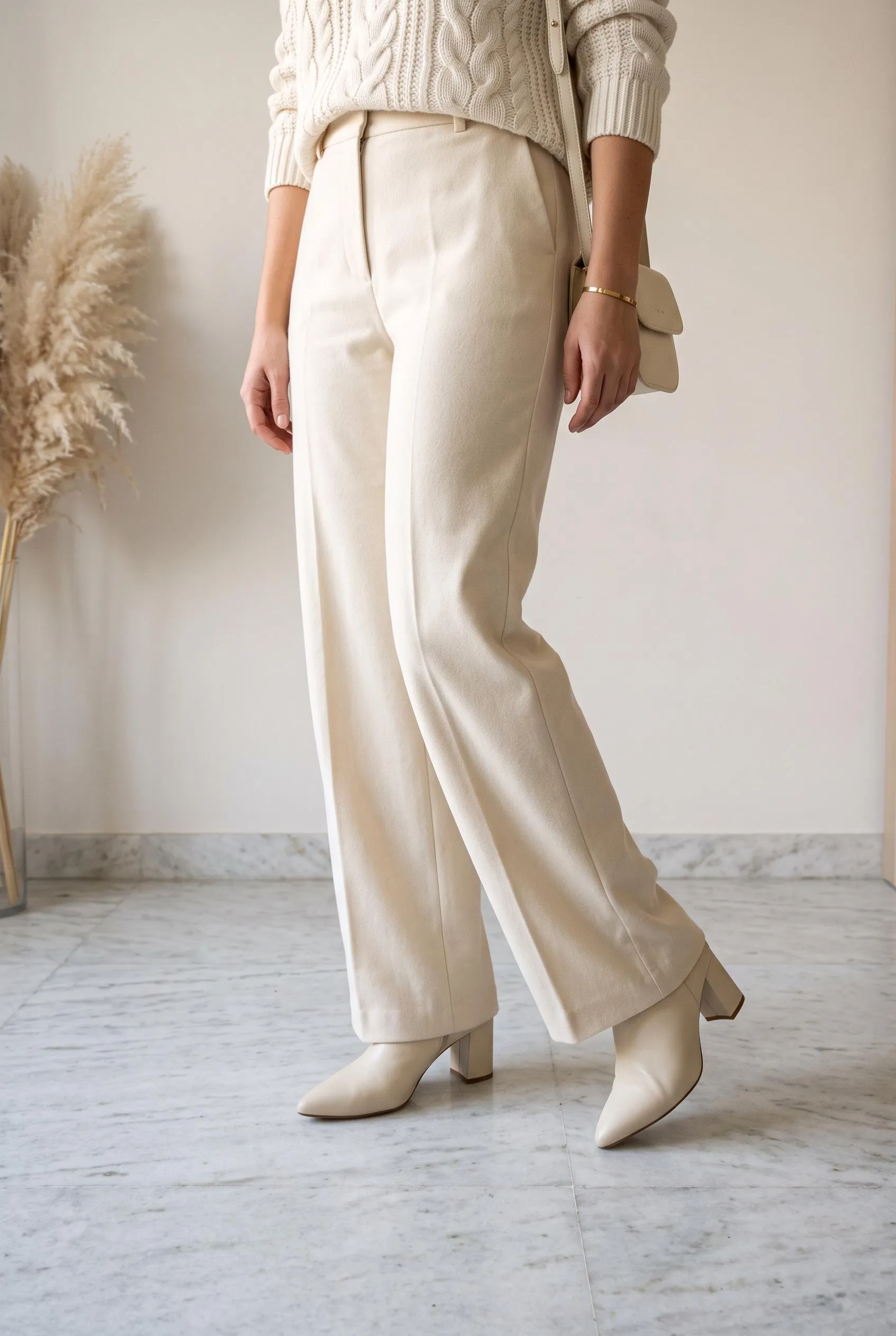 All-cream outfit with cream wide-leg trousers, an ivory knit and cream pointed ankle boots