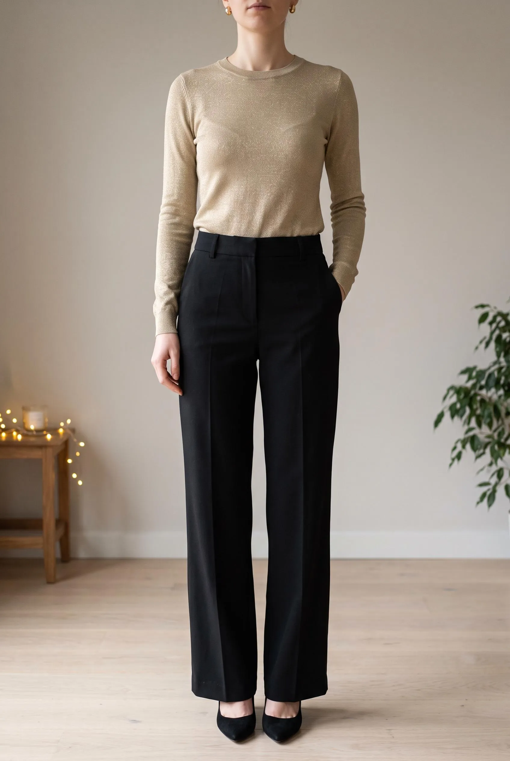 Gold knit top with black wide-leg trousers and black pumps