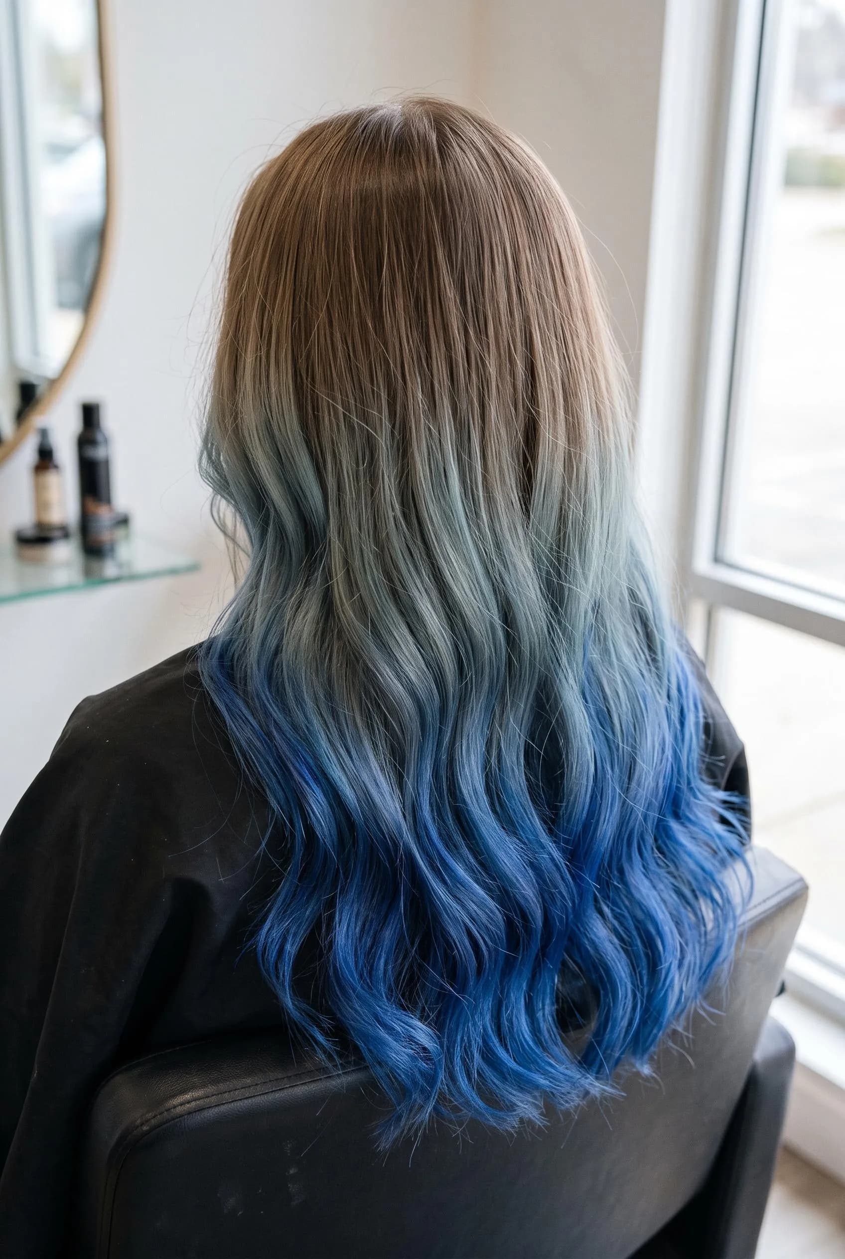 Light brown roots melting into bright cobalt blue ombre waves