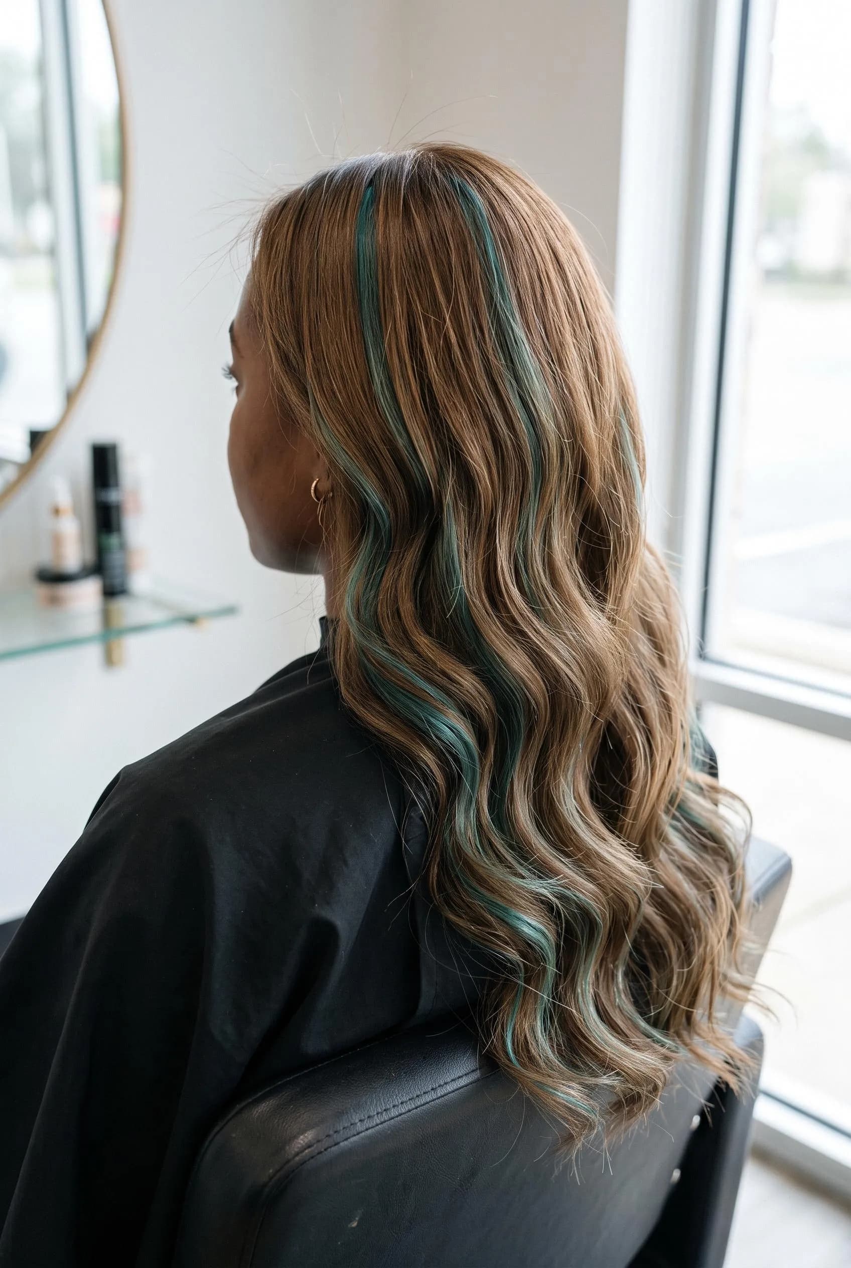 Warm light brown waves with teal blue-green highlights