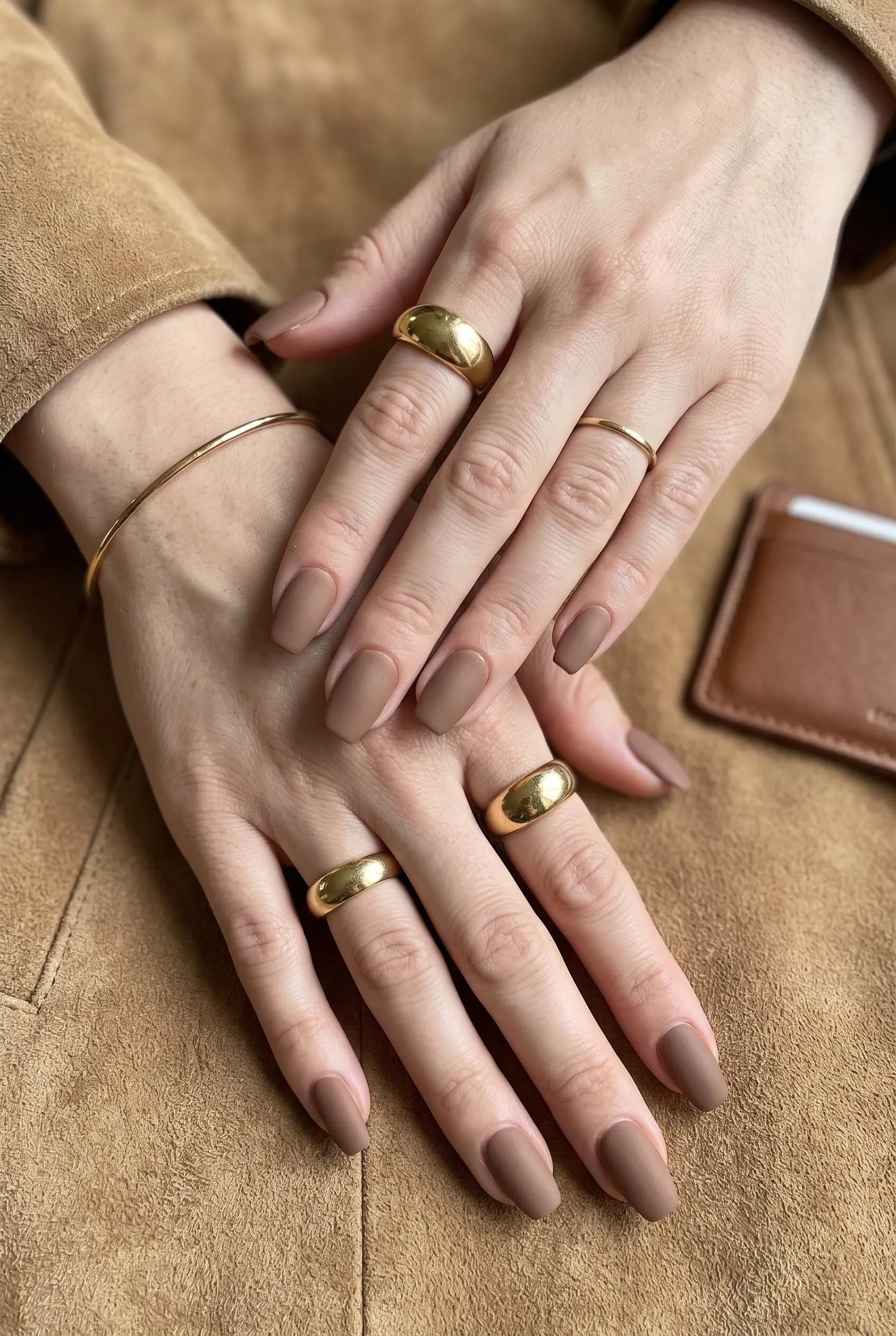 Matte mocha coffin nails on a camel suede jacket