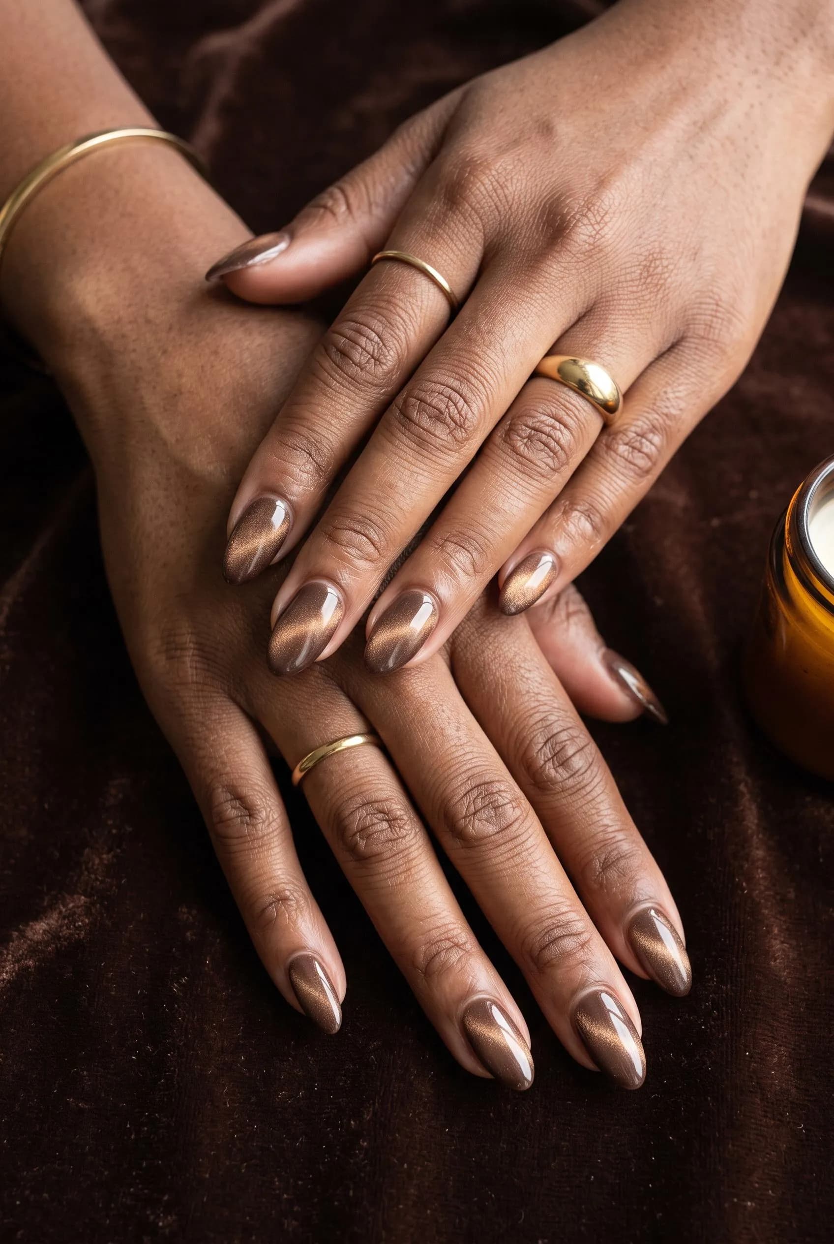 Tonal set of latte, mocha and espresso brown nails beside cups of coffee