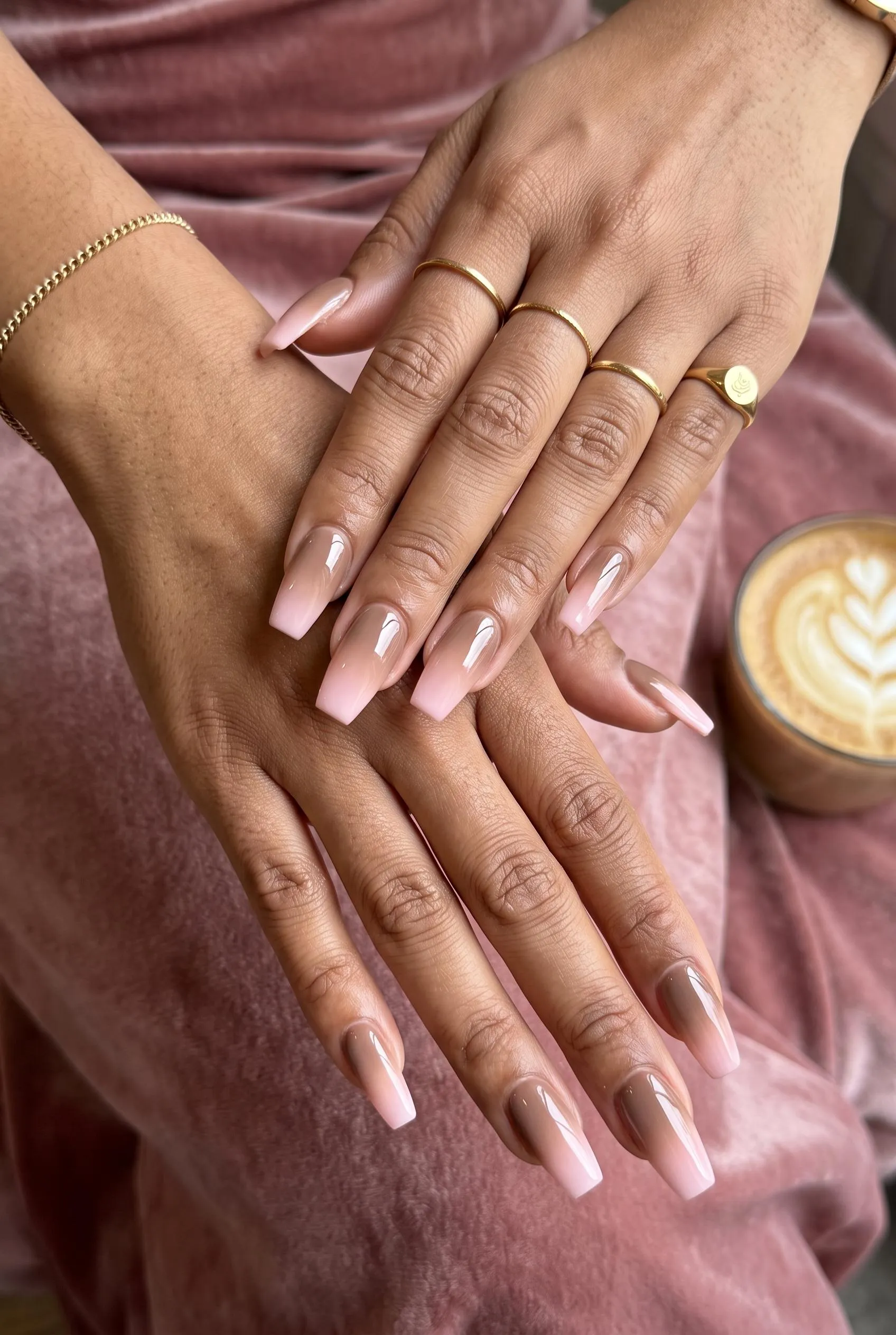 Long nails with a mocha brown to soft pink ombre on dusty rose velvet