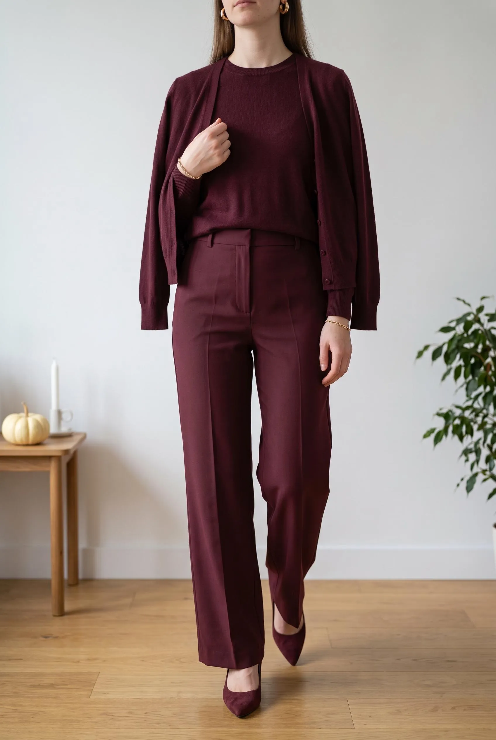 Head-to-toe burgundy knit, wide-leg trousers and pointed burgundy pumps